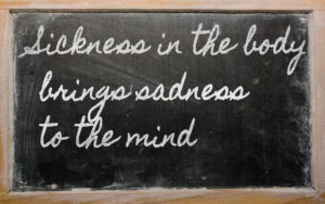 Sickness in the body brings sadness to the mind - written on a school blackboard with chalk image